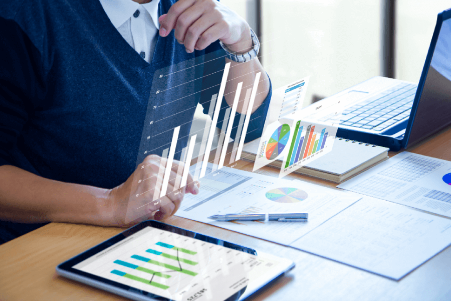 A man examines graphs displayed on a tablet, focusing intently on the data presented.