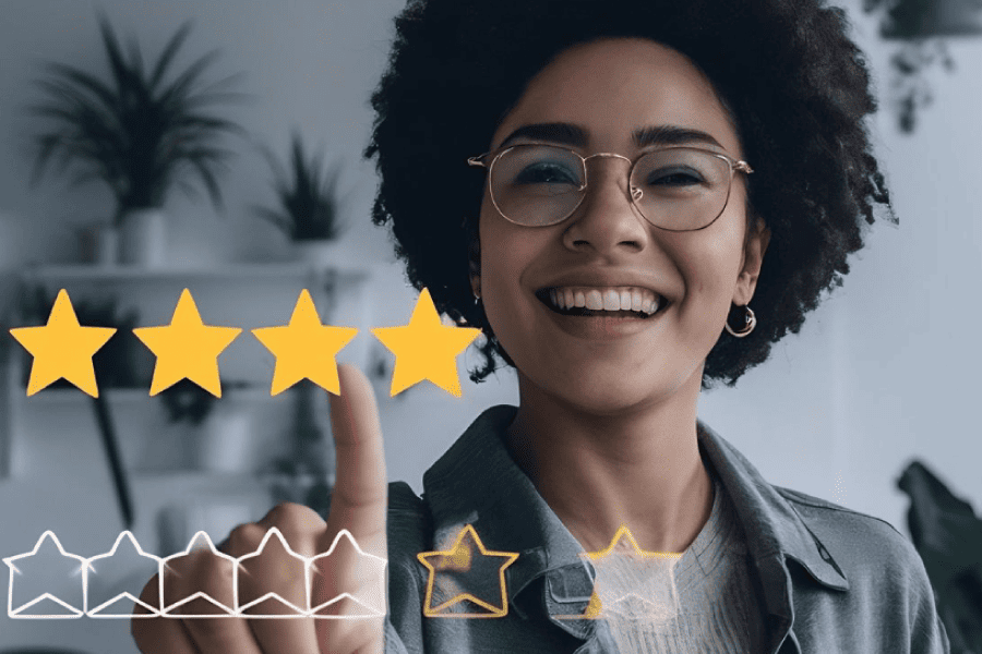 A smiling woman with glasses points at five star ratings, indicating high satisfaction or approval.