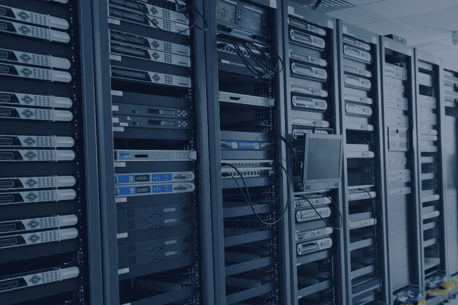 A server rack filled with multiple servers and a computer, showcasing a modern data center setup.